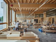 a man working in a woodworking shop with lots of workbench and tools