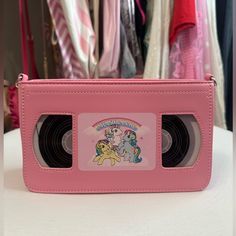 This Novelty Vhs-Shaped Crossbody Bag Has A Sweet Vegan Leather Construction, A Detachable Chain Strap, A Top Zip Closure, And My Little Pony Graphics On The Front. Man Made Materials Approx. 8.5" W X 5" H X 2.5" D Brand New! Never Used Or Carried! The Shoulder Strap Is Still Wrapped Up Inside. Feel Free To Message Me With Any Questions And Remember To Check Out My Other Items! Happy Poshing! Korean Bags, Funky Purses, Sheer Gloves, Barbie The Movie, Clear Cosmetic Bag, Nostalgic Candy, My Style Bags, Pink Kawaii, Victoria Secret Tote Bags