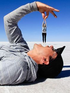 a man laying on the ground with his hand up in the air above his head