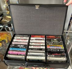 A fantastic estate auction find! Vintage Cassette Stirage Case from the 1970s with an interesting assortment of vintage cassette tapes. The case is black vinyl that is accented with red checked pattern. There is a handle at the top and a gold toned metal closure. Inside the case is an eclectic assortment of 24 vintage cassette tapes including: Elvis Presley (12), Elton John, Alice In Chains, LL Cool J, Dean Martin, and more!   In good vintage condition.  Minor age related wear - no rips or cracks to the vinyl - just needs a good cleaning. A fun addition to a vintage audio collection. Cassette Storage, Cds And Cassettes, Cassette Phone Case, 80s Cassette Tapes, 90s Cassette Tapes, 1980s Cassette Tapes, Vintage Cassette, Ll Cool J, Dean Martin