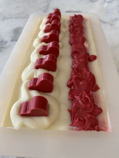 a cake decorated with red and white icing