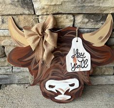 a wooden buffalo head with a tag that says hey sale hanging from it's side