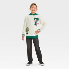 Bring fun style to their cool-weather wardrobe with this Teenage Mutant Ninja Turtles Fleece Pullover Sweatshirt. This hooded sweatshirt is crafted from midweight fleece fabric for all-day cozy comfort, and it's designed with a ribbed hem and cuffs for a neat finish. Designed in a cream hue with a green hood and hem, and green and brown varsity stripes on the sleeves, it features a graphic showing Leonardo, Michelangelo, Donatello and Raphael for a fan-favorite look. Playful Winter Hoodie, Playful Fleece Sweatshirt For Winter, White Winter Hoodie For School, Sporty Winter School Sweater, Playful Long Sleeve Fleece Sweatshirt, White Winter Sweater For School, Playful Crew Neck Hoodie For Winter, Winter Cotton Hoodie For School, Playful Crew Neck Winter Sweatshirt