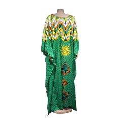 Add a touch of African fashion to your wardrobe with our gorgeous maxi dresses! These dresses feature oversized designs and beautiful African lace that are perfect for any occasion. Floor-length Printed Boho Dress For Vacation, Elegant Green Beach Cover-up Dress, Green Long Sleeve Maxi Dress For Summer, Floor-length Printed Boho Vacation Dress, Printed Floor-length Boho Vacation Dress, Printed Long Dress For Vacation, Green Printed Flowy Dresses, Flowy Printed Long Maxi Dress, Flowy Long Summer Gown