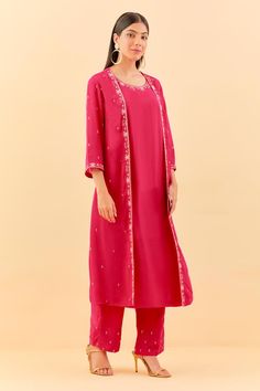 Hot pink three fourth sleeves A-line kurta with floral sequins, beads, nalki embroidered attached long jacket in chanderi cotton base. Paired with matching pant.
Components: 2
Pattern: Embroidery
Type Of Work: Sequin, Beads
Neckline: Round
Sleeve Type: Three Fourth
Fabric: Chanderi Cotton, Cotton Silk
Color: Pink
Other Details: 
Attached inner lining
Model Height: 5ft 6inches, wearing size L
Occasion: Sangeet, Mehendi and Haldi - Aza Fashions Pink Anarkali Set With Floral Embroidery And Long Sleeves, Traditional Wear With Gota Work For Spring, Spring Traditional Wear With Gota Work, Spring Anarkali Set With Mirror Work And Straight Kurta, Festive Pink Chanderi Nehru Jacket, Spring Salwar Kameez With Mirror Work And Long Sleeves, Spring Long Sleeve Salwar Kameez With Mirror Work, Spring Festive Kurta With Gota Work, Spring Anarkali Set With Gota Work And Straight Kurta