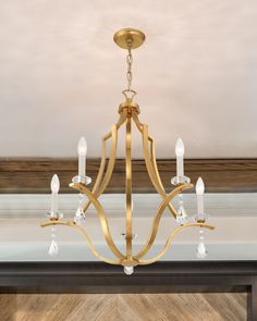 a chandelier hanging from the ceiling in a room with wood floors and walls