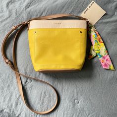 Nwt Anne Klein Bucket Crossbody Bag. Yellow With White And Tan Trim. All Man Made Material. Front Snap Pocket. Inside Zip Pocket. 9”X8”X4”. Spring Crossbody Bucket Bag For On-the-go, Yellow Crossbody Satchel For Spring, Spring Crossbody Satchel For Errands, Spring Yellow Bucket Bag With Adjustable Strap, Yellow Shoulder Bag For Spring On-the-go, Yellow Crossbody Bucket Bag For Errands, Anne Klein Bags, Brown Crossbody Purse, Tan Trim