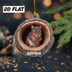 a christmas ornament shaped like a squirrel in a log with the word sophiia printed on it