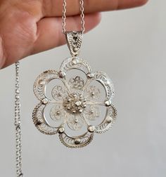 Delicate Silver Pendant Necklace, Ornate White Gold Pendant Necklace, Engraved White Gold Flower Pendant Necklace, Traditional Necklace With Intricate Flower Pendant, Traditional Flower Pendant Necklace With Intricate Design, Ornate White Gold Necklace With Intricate Design, White Gold Necklace With Large Flower Pendant, Engraved Flower Shape Necklaces, Luxury White Gold Necklace With Large Flower Pendant