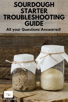 two jars filled with sand sitting on top of a wooden table next to each other