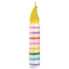 a multicolored candle with a yellow top on it's end and a white background