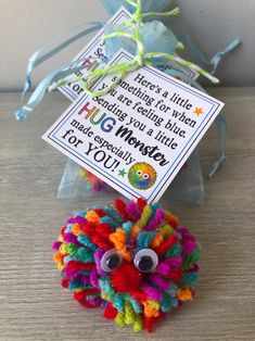 a colorful pom - pom with a tag attached to it