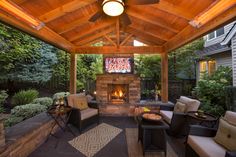 a covered patio with furniture and a fire place