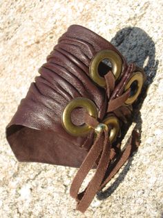 "Crushed Italian leather hand sculpted Cuff Bracelet Wristband BROWN Italian LEATHER WITH ANTIQUE GOLD TRIM (Other color combinations listed below) Black , Dark Green and Red come with Silver color Grommets Caramel and Tan come with Gold Grommets Distressed Red, Brown come with Antique Gold Grommets. Most Other colors may be available upon request. (other sizes may be available upon request.) Crushed Italian Leather.Sculpted into the wrist shape. (permanent firm sculpted shape) Color Card can be Leather Bracelet Cuff, Brown Cuff Leather Bracelet, Brown Leather Cuff Bracelet, Leather Festival Bracelet, Adjustable Medieval Bangle Cuff Bracelet, Handmade Medieval Cuff Bracelet For Gifting, Medieval Adjustable Bangle Cuff Bracelet, Handmade Medieval Cuff Bracelet As Gift, Medieval Handmade Cuff Bracelet As A Gift