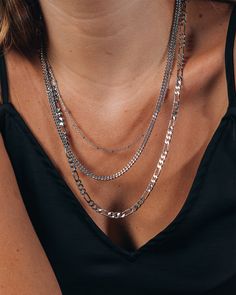 Layered necklaces are super on-trend, and these layered chains are sure to get you noticed everywhere you go! Choose between the gold and silver tones -- both are bright and bold, yet versatile enough to wear anywhere. Materials: 14K gold or rhodium plated brass Features: Measures 18-22" with 2" extender, 4.5mm Figaro chain, 3mm curb chain, 1mm beaded chain, Lead & Nickel free, lobster clasp Trendy Multi-strand Chunky Chain Jewelry, Trendy Multi-strand Charm Necklaces, Everyday Long Silver Chain Necklace, Trendy Layered Necklace With Double Chain Link, Trendy Layered Chain Link Necklace, Trendy Link Chain Necklace For Layering, Trendy Chain Link Layered Necklace, Silver Chain Link Layered Necklace, Trendy Multi-strand Layered Chain Necklace