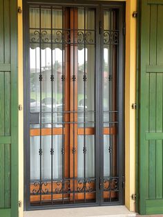 the front door to a building with green and yellow trimmings on it's sides