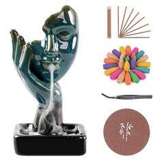 a sculpture is shown next to some crafting supplies and scissors on a white background