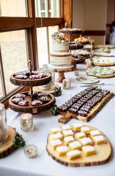 a table topped with lots of cakes and desserts