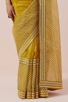 Mustard yellow saree in silk organza base with silver and gold aari, sequin and zari work. Paired with a halter neck blouse and petticoat. - Aza Fashions Gold Pre-draped Saree With Gota Work In Organza, Transitional Gold Pre-draped Saree With Gota Work, Gold Organza Pre-draped Saree For Navratri, Elegant Yellow Saree For Transitional Season, Yellow Organza Pre-draped Saree For Party, Yellow Pre-draped Saree For Transitional Wedding Season, Elegant Yellow Traditional Wear For Festivals, Elegant Yellow Pre-draped Saree For Festive Occasions, Yellow Anarkali Style Pre-draped Organza Saree