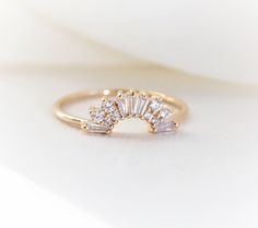 "This elegantly handmade vintage Art Deco-inspired wedding band features a glittering cluster of tapered baguettes and round stones. Before you order the band, please order a home try-on wax model here https://etsy.me/2TRvaLz There will be a 20% restocking fee deducted from your refund in case you need to return the band. So we highly recommend ordering the wax sample to see how it fits with your engagement ring. ❁❁ I T E M ∙ D E T A I L S ❁❁ ✦Stone: Conflict-Free Natural White Diamonds (SI or b Crown Band Ring, Wedding Band Above Engagement Ring, Art Deco Engagement Ring And Wedding Band, Round Engagement Ring With Curved Wedding Band, Art Deco Curved Wedding Band, Wedding Band Contour, Vintage Inspired Engagement Rings Art Deco Diamond, Baguette Cut Sparkling Jewelry For Wedding, Sparkling Baguette Cut Jewelry For Wedding