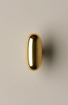 an image of a gold door knob on a white wall with no one in it