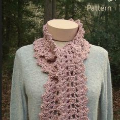 a pink crocheted scarf on top of a mannequin