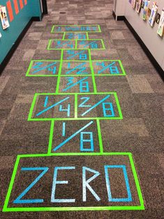 the floor is decorated with different colored letters and numbers on it, as well as an area for games to play