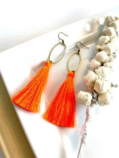 **FREE SHIPPING ON ORDERS OF $35 OR MORE**In these modern dangles, high quality silk tassels dangle from a cool brass oval charm.► LENGTH. The earrings measure 3.25 inches from  top of the ear wire to the bottom bead.► COLOR.  These earrings are available in a wide variety of colors including neon orange, maroon, taupe, gray, black, white, red, neon yellow, dark green, navy blue, purple, hot pink, and light pink.► Follow me on INSTAGRAM and FACEBOOK @bevinboldjewelry to receive coupon codes and Orange Fringe Tassel Earrings For Gift, Bohemian Orange Tassel Earrings, Orange Tassel Dangle Earrings, Orange Fringe Earrings As A Gift, Orange Fringe Earrings As Gift, Orange Earrings For Spring Beach Outing, Bohemian Orange Earrings For Spring, Vibrant Orange Summer Earrings, Bohemian Orange Jewelry For Spring