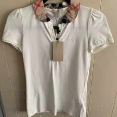 Xs White, Buttons, Burberry Ruffles Collar, Burberry Logo. Small Stain On Top Left Side. Designer White Tops For Workwear, Designer White Collared Top, Burberry Top Outfit, Burberry T Shirt Woman Outfit, Burberry Crop Top, Ruffles Collar, Burberry Polo Shirt, Turquoise Shorts, Burberry Tops