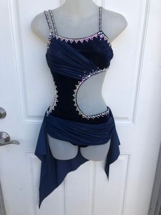 a mannequin wearing a blue dress with beading on it