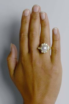 This amazing white South Sea pearl and diamond cocktail ring is centered by a huge, 11.4 mm perfectly round glowing dome of high luster with a mesmerizing rose overtone. The flawless complexion mirrors the fire of the 14 diamonds arranged in asymmetrical pattern, all set in a rich, 18k yellow gold. Condition: Very Good Era: Modern Estate Year: 1980s Metal: 18K Yellow Gold Center Gemstone: South Sea Pearl Diameter: 11.4mm Color: White, rose overtone Complexion: Near-flawless Shape: Round Luster: Elegant White Domed Rings, Elegant White Domed Jewelry, Luxury Cabochon Pearl Ring For Wedding, Luxury Cabochon Pearl Wedding Ring, Luxury Pearl Ring With Rose Cut Diamonds, Luxury Round Pearl Ring With Rose Cut Diamonds, Luxury Pearl Cabochon Ring For Formal Occasions, Luxury Formal Pearl Ring With Cabochon, Gold Statement Jewelry