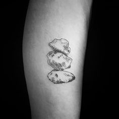 a black and white photo of some rocks on the side of a man's leg