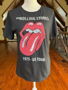 Take your concert tee game to the next level in this hand-rhinestoned crew neck Rolling Stones T-shirt! Swarovski crystals are hand placed across chest lettering for maximum light reflection Manufacturer is H and M brand, size Small. 100% Cotton. Laid flat, t-shirt measures: Chest: 18.5" armpit to armpit Front Length: 23" from neck to hem Back Length: 25" from neckline to hem Sleeve: 8" from shoulder to hem of sleeve Having been a fan of multiple pro and college sports, I had a hard time finding cute, feminine shirts, so I made my own! Now I source the cutest women's sports shirts on the market and custom match genuine Swarovski crystals, each of which is hand placed for one-of-a-kind creations. Prepare to be stopped many times for compliments and to be asked, "Where did you find that?" Wh Feminine Shirts, H&m Brand, H And M, Custom Matches, Concert Tees, College Sports, Hard Time, Light Reflection, Cute Woman