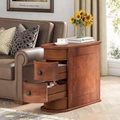 a living room scene with focus on the sofa and side table that has two drawers