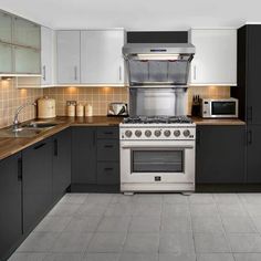 a kitchen with an oven, microwave and counter tops in black and white color scheme