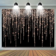 three lights are hanging from the ceiling in front of a black background with white stars