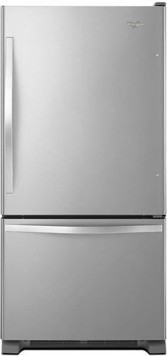 a silver refrigerator freezer sitting on top of a white counter