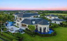 this is an aerial view of the house and its surrounding grounds at sunset or dawn