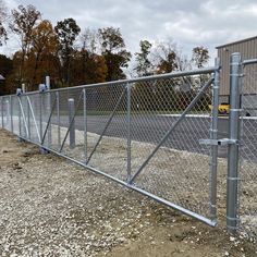 a large chain link fence next to a parking lot