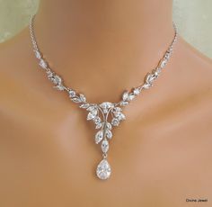 This beautiful cubic zirconia set comes with necklace and earrings.   This crystal jewelry set comes with necklace and earrings. It has the perfect amount of sparkle for your Old Hollywood Glam, vintage wedding, formal event, special occasion. Necklace is available from 14" to 22" long.  Focal point measures approximately 5 3/4" wide by 2 1/4" long including the teardrop.  Finished with rhodium plated chain and a lobster claw closure. It comes with a 2" extender chain for additional length. Chandelier earrings are about 1 7/8" long from top to bottom.  Perfect for a classy bride or any special occasion! Necklace can be extended up to 18" long without extra charge if specified at the time of ordering. Matching bracelet, https://www.etsy.com/listing/644578685/crystal-bracelet-cubic-zirconia- Statement Necklace Wedding, Bridal Earrings Studs, Bridal Earrings Chandelier, Bridal Necklace Set, Old Hollywood Glam, Crystal Jewelry Sets, Wedding Formal, Hollywood Glam, Wedding Jewelry Sets