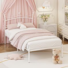 a white bed sitting in a bedroom next to a pink curtain