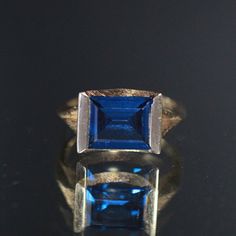 Absolutely Beautiful! Featuring This 14k Gold Ring Mounted With 3.29 Cts Squared Blue Synthetic Spinel Bezeled Set In A Textured Modernist Setting. This Is Size 6 And Weighs 3.38 Grams. Stock Code: 2p2205-3-24 Modern Blue Sapphire Ring In 14k Gold, Modern Blue Sapphire Ring For Formal Occasions, Modern Blue Diamond Cut Rings, Modern Rectangular Blue Sapphire Ring, Modern Blue Rectangular Sapphire Ring, Blue Emerald Cut 14k Gold Sapphire Ring, Elegant Blue Sapphire Ring In 14k Gold, Blue Emerald Cut Birthstone Jewelry, Formal Blue Sapphire Ring