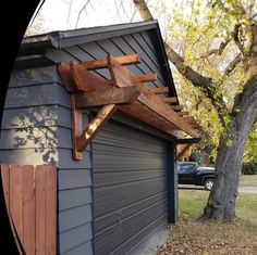 an image of a garage with a wooden structure attached to it's side wall