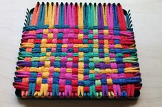 a multicolored basket sitting on top of a wooden table