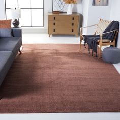 a living room filled with furniture and a brown rug