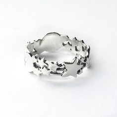 "This is a sterling silver band representing the galaxy with Moon stars and planets. The ring width of the band is 3/8\" inch. Handmade to order. Size adjustments may be possible, so if you're interested in this ring in a size not listed, please message us before purchasing! We charge a $10 fee to resize." Silver Star-shaped Celestial Midi Rings, Celestial Silver Star Midi Rings, Celestial Style Sterling Silver Stackable Rings, Celestial Silver Midi Rings For Anniversary, Celestial Silver Ring With Moon Phase, Silver Celestial Open Ring, Adjustable Celestial Sterling Silver Stackable Rings, Celestial Silver Midi Promise Rings, Celestial Silver Stackable Rings