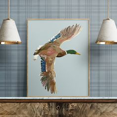 a duck flying through the air in front of a blue wall with two lamps hanging above it