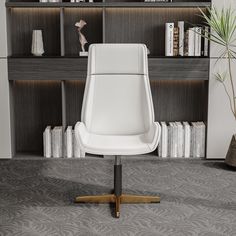 a white office chair sitting in front of a book shelf