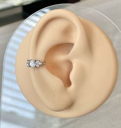 a close up of a fake ear with a ring on it