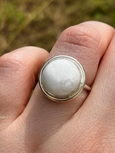 Howlite and Sterling Silver Ring - UK Size L This ring features a Fine Silver bezel set Howlite on a Sterling Silver band with a halo detail around the stone. UK Size L. All silver used is 100% recycled. This ring was handmade in my home-workshop in Northamptonshire. Every purchase is sent via Royal Mail Tracked 48 - you will receive the tracking number in the dispatch email. Please check the delivery upgrades if you would like a speedier delivery option. All international orders are sent via Ro Minimalist Jewelry With Center Stone In Round Band, Fine Jewelry Stackable Halo Rings, Fine Jewelry Halo Stackable Rings, Classic Rings With Halo And Round Stone, Classic Round Opal Ring, Fine Jewelry Rings With Smooth Bezel, White Pearl Ring With Center Stone, Round Jewelry With Smooth Bezel For Wedding, Smooth Bezel Ring Jewelry